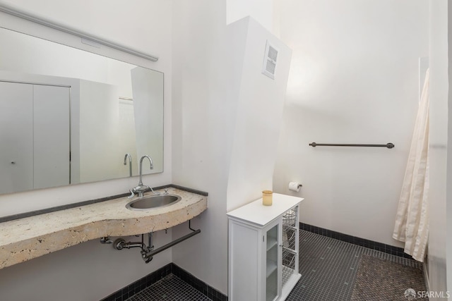 bathroom with tile patterned flooring and sink