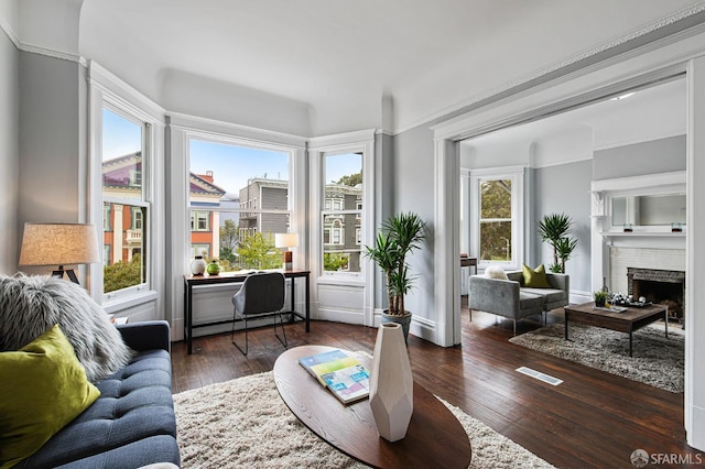 sunroom featuring a brick fireplace