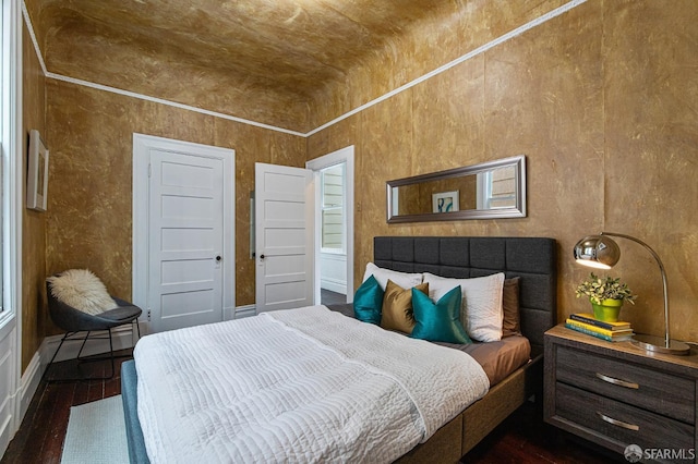 bedroom with brick ceiling, lofted ceiling, and dark hardwood / wood-style floors