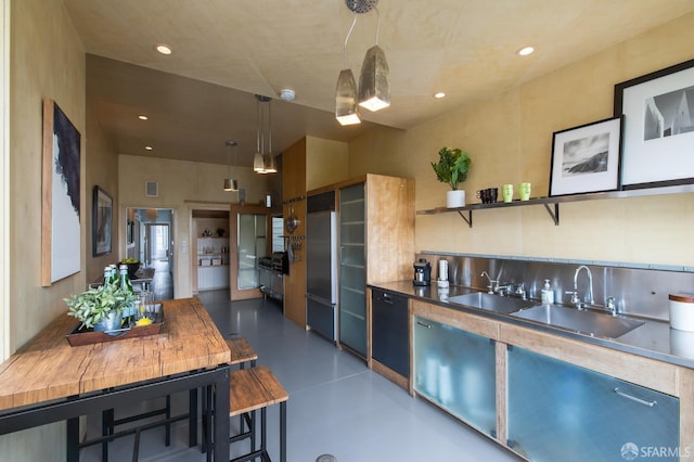 kitchen featuring sink, dishwasher, hanging light fixtures, wood counters, and built in refrigerator