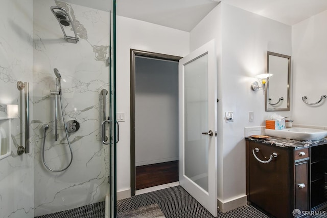 bathroom featuring vanity and an enclosed shower