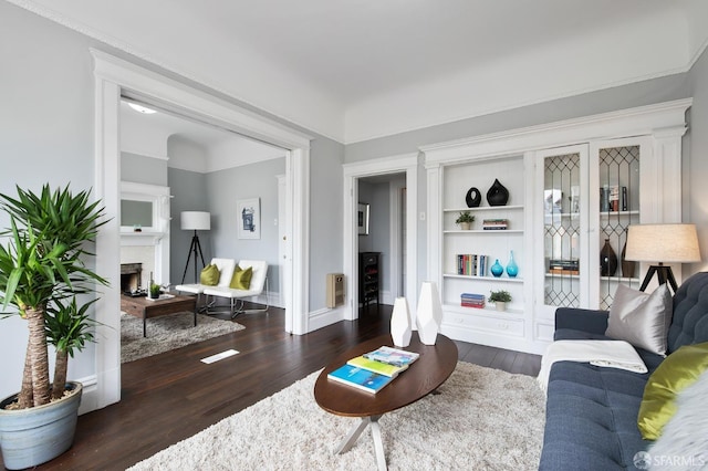 living room featuring heating unit and dark hardwood / wood-style floors