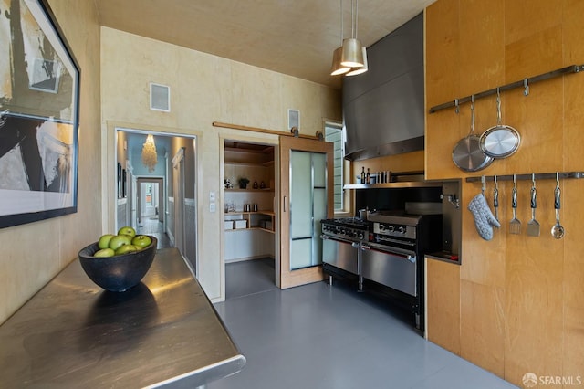 kitchen featuring stainless steel counters, built in features, hanging light fixtures, and range hood