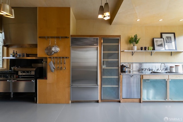 kitchen with ventilation hood, stainless steel appliances, hanging light fixtures, and sink