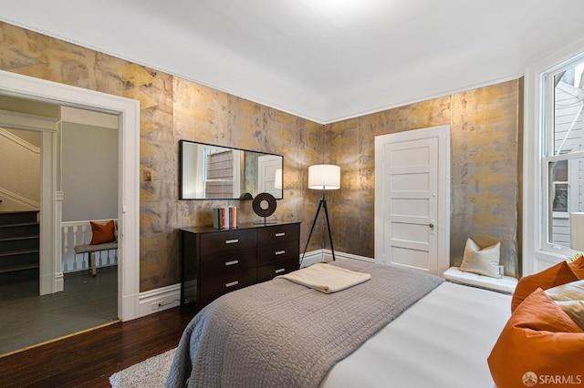 bedroom with dark hardwood / wood-style floors