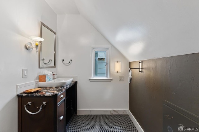 bathroom featuring vanity and vaulted ceiling