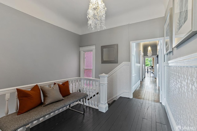 hallway featuring dark hardwood / wood-style floors and a notable chandelier