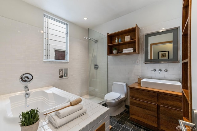 full bathroom with vanity, toilet, tile walls, and independent shower and bath