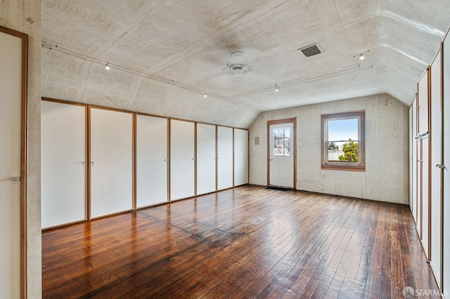 spare room featuring hardwood / wood-style flooring, ceiling fan, and lofted ceiling