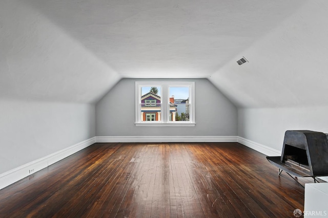 additional living space featuring dark hardwood / wood-style floors and vaulted ceiling