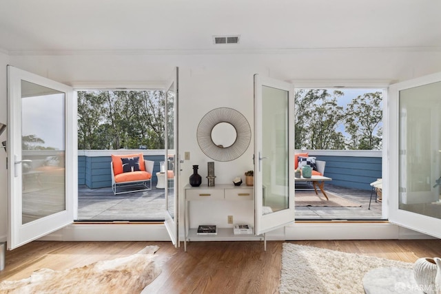 302 Warren Dr, San Francisco, CA 94131 - doorway with healthy amount of natural light, wood finished floors, crown molding, and french doors