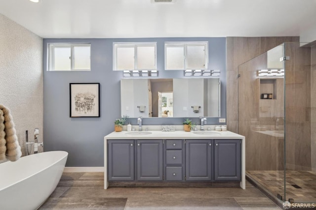 302 Warren Dr, San Francisco, CA 94131 - bathroom featuring a shower stall, double vanity, a freestanding tub, and wood finished floors