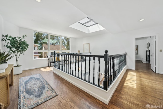 302 Warren Dr, San Francisco, CA 94131 - corridor featuring a skylight, an upstairs landing, wood finished floors, and recessed lighting