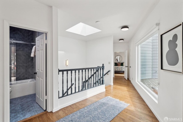 302 Warren Dr, San Francisco, CA 94131 - corridor featuring a skylight, an upstairs landing, and wood finished floors