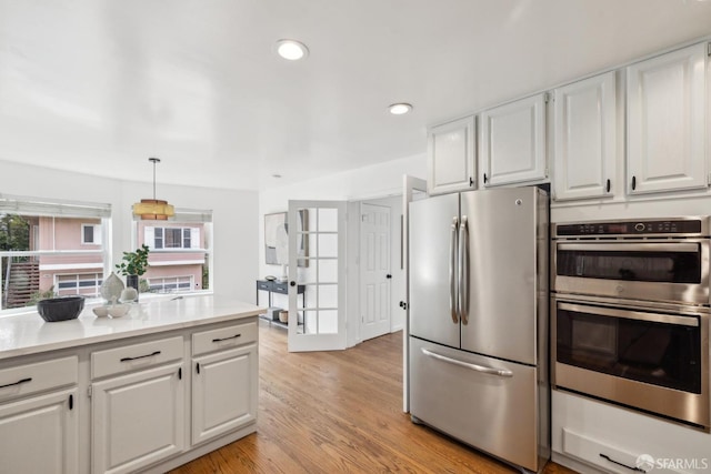302 Warren Dr, San Francisco, CA 94131 - kitchen featuring appliances with stainless steel finishes, white cabinets, light countertops, light wood finished floors, and recessed lighting