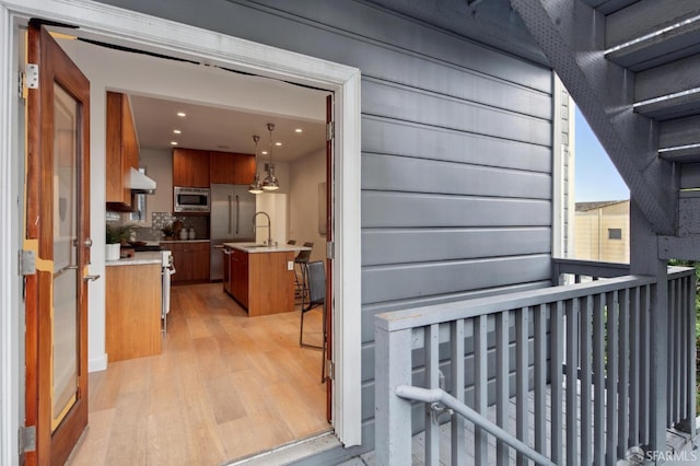 entrance to property with sink and a balcony