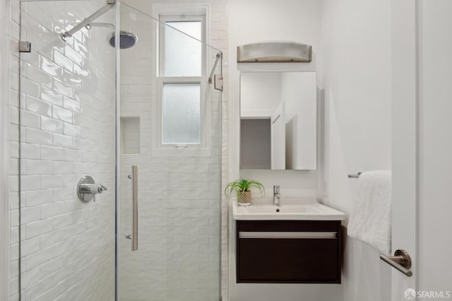 bathroom featuring vanity, plenty of natural light, and walk in shower