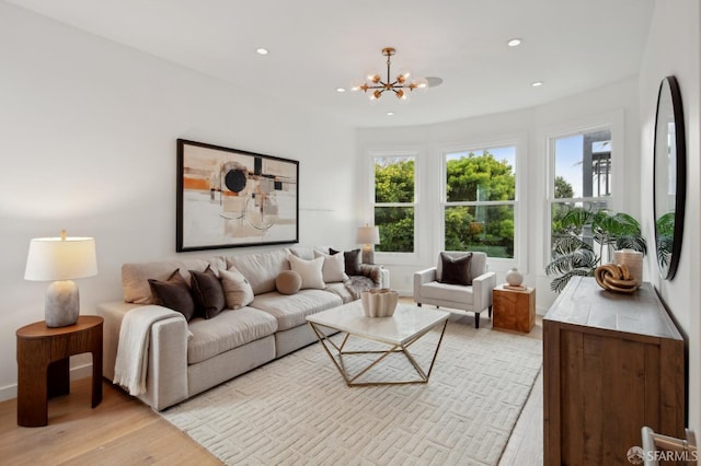 living room featuring a chandelier and light hardwood / wood-style flooring