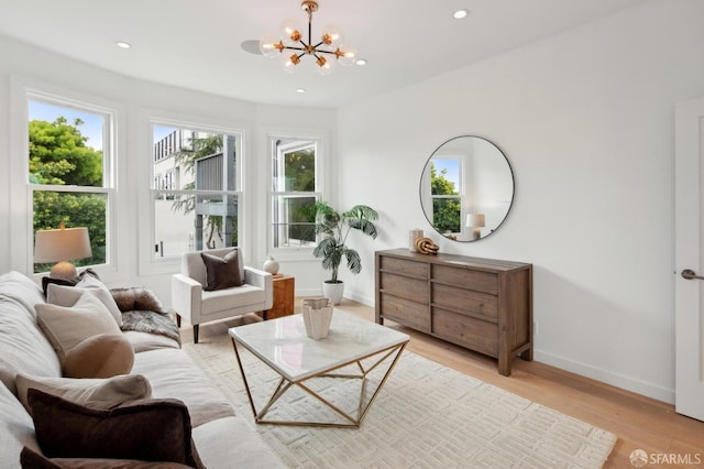 living area featuring a chandelier and light hardwood / wood-style flooring