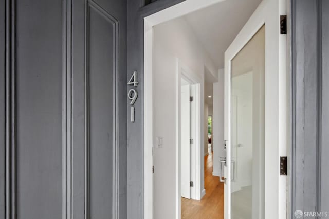 hallway with light hardwood / wood-style floors