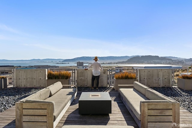 wooden deck featuring a mountain view and an outdoor living space