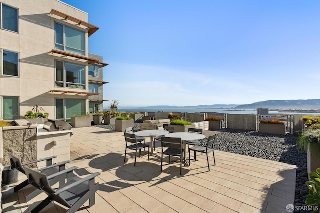 view of patio / terrace featuring a mountain view and an outdoor kitchen