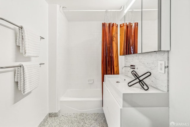 bathroom featuring sink, shower / bath combo with shower curtain, and backsplash