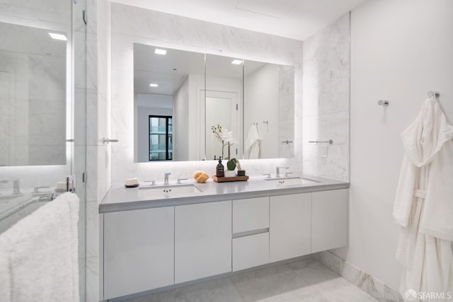 bathroom with vanity and a shower with door