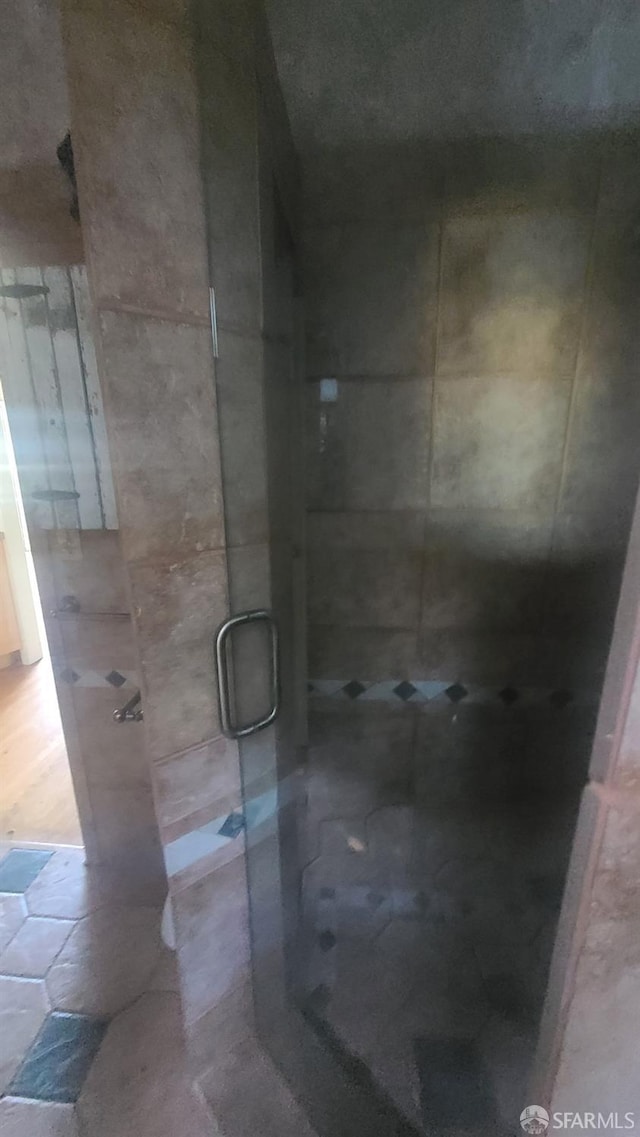 bathroom with a shower with door