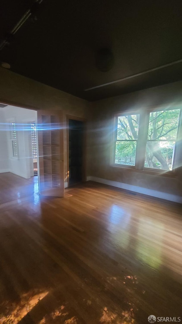 unfurnished room with hardwood / wood-style floors