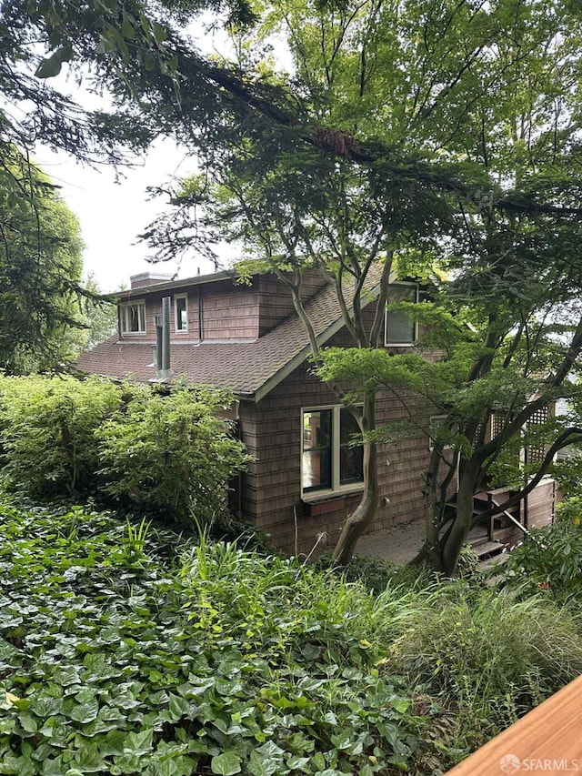 30 Harry St, San Francisco, CA 94131 - view of home's exterior featuring a chimney and roof with shingles