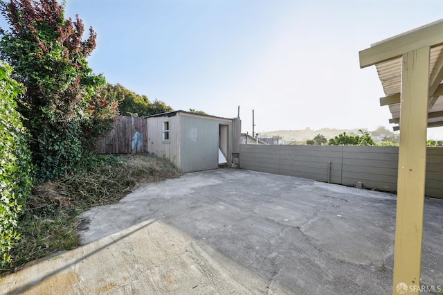 1527 Palou Ave, San Francisco, CA 94124 - view of patio / terrace featuring an outdoor structure, a fenced backyard, and a shed