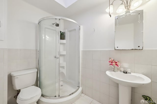 1527 Palou Ave, San Francisco, CA 94124 - bathroom featuring tile walls, a shower stall, wainscoting, and toilet