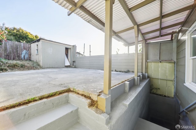 1527 Palou Ave, San Francisco, CA 94124 - view of patio featuring fence and an outbuilding