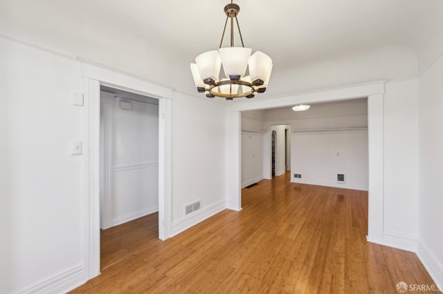 1527 Palou Ave, San Francisco, CA 94124 - spare room with a chandelier, light wood-style floors, and baseboards