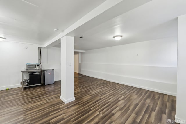 1527 Palou Ave, San Francisco, CA 94124 - finished below grade area with refrigerator, baseboards, and dark wood finished floors