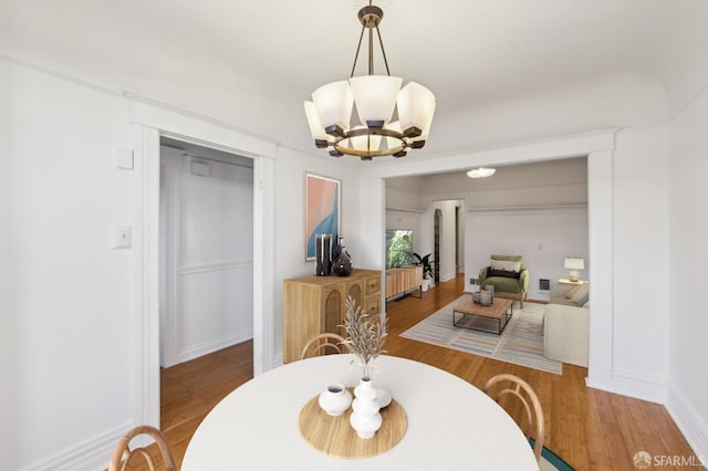 1527 Palou Ave, San Francisco, CA 94124 - dining area with wood finished floors, a chandelier, and baseboards