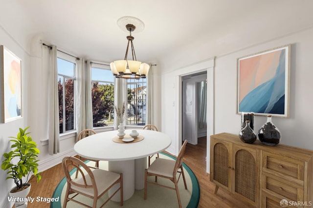 1527 Palou Ave, San Francisco, CA 94124 - dining room featuring a chandelier and light wood finished floors