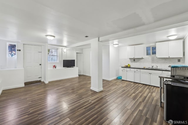 1527 Palou Ave, San Francisco, CA 94124 - kitchen with open floor plan, dark wood-type flooring, white cabinetry, dark countertops, and decorative backsplash