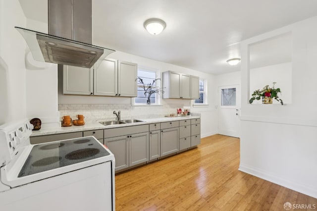 1527 Palou Ave, San Francisco, CA 94124 - kitchen with white electric range oven, a sink, island range hood, gray cabinetry, and light countertops