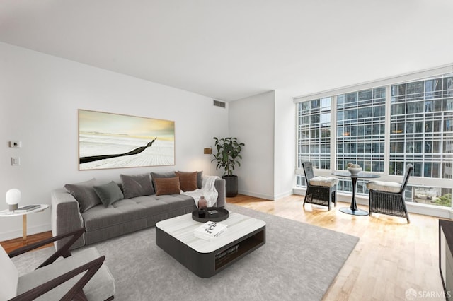 301 Mission St Unit 6J, San Francisco, CA 94105 - living area featuring light wood-type flooring and a wall of windows