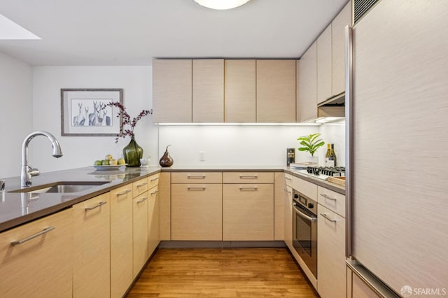 301 Mission St Unit 6J, San Francisco, CA 94105 - kitchen with fridge, stainless steel oven, light brown cabinetry, light wood-style floors, and gas stovetop