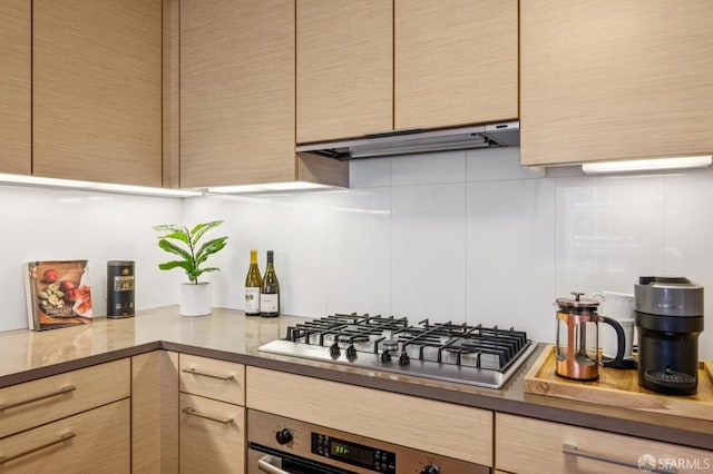 301 Mission St Unit 6J, San Francisco, CA 94105 - kitchen featuring stainless steel gas cooktop, wall oven, under cabinet range hood, and light brown cabinetry