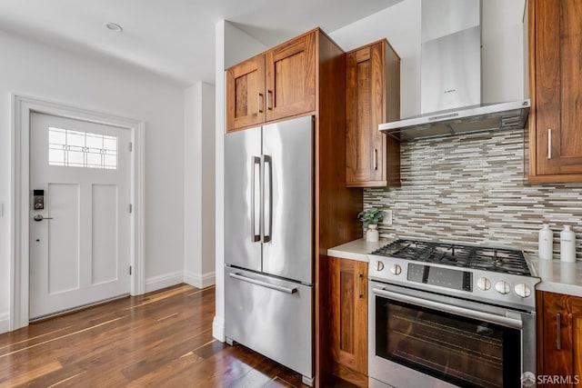 2486 Fulton St, San Francisco, CA 94118 - kitchen featuring appliances with stainless steel finishes, ventilation hood, brown cabinetry, dark wood-style floors, and decorative backsplash