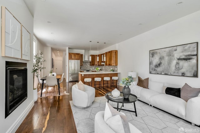 2486 Fulton St, San Francisco, CA 94118 - living room featuring light wood-type flooring, a glass covered fireplace, baseboards, and recessed lighting
