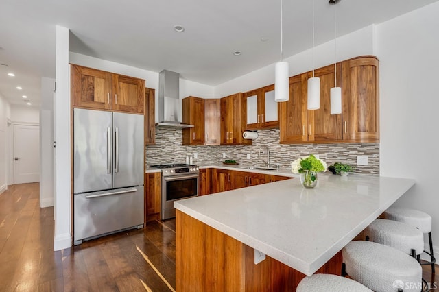 2486 Fulton St, San Francisco, CA 94118 - kitchen with stainless steel appliances, wall chimney range hood, a sink, brown cabinetry, and recessed lighting