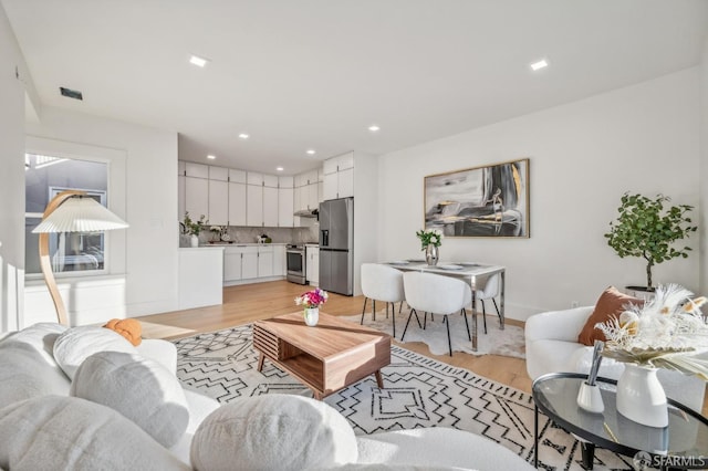 31 Romolo Pl Unit 6, San Francisco, CA 94133 - living area with light wood finished floors, visible vents, recessed lighting, and baseboards