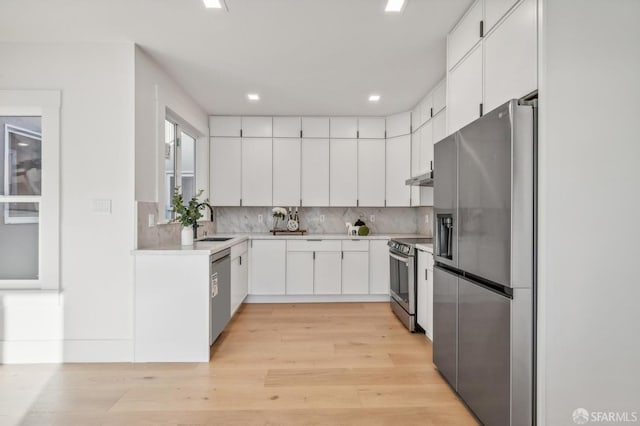 31 Romolo Pl Unit 6, San Francisco, CA 94133 - kitchen with light countertops, decorative backsplash, light wood-style floors, stainless steel appliances, and a sink
