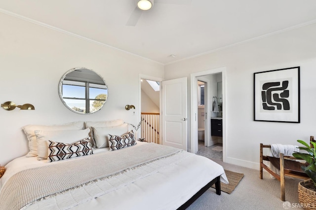 bedroom with ceiling fan, connected bathroom, crown molding, and light carpet