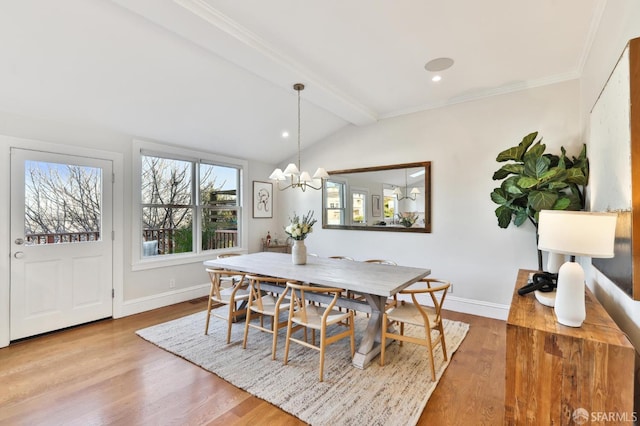 dining area featuring ornamental molding, vaulted ceiling with beams, light hardwood / wood-style floors, and an inviting chandelier